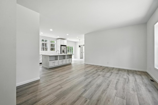 4 Willis Rd, Benton, ME 04901 - unfurnished living room with recessed lighting and light wood-style floors