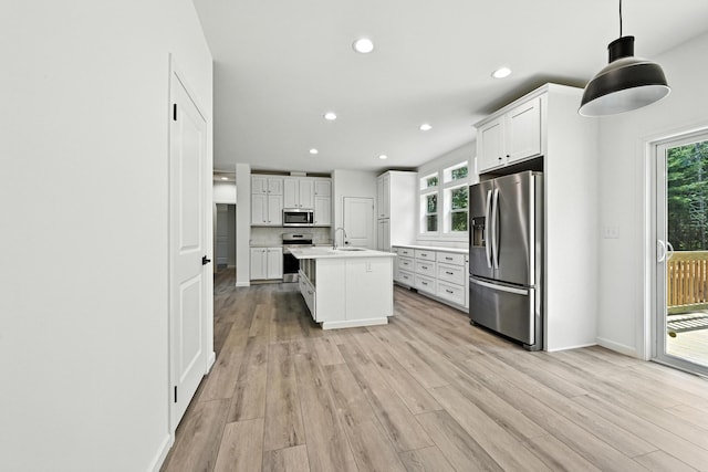 4 Willis Rd, Benton, ME 04901 - kitchen with stainless steel appliances, light countertops, light wood-type flooring, recessed lighting, and white cabinetry
