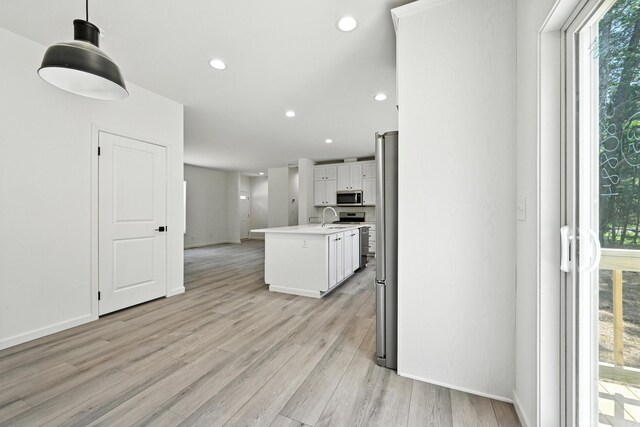 4 Willis Rd, Benton, ME 04901 - kitchen featuring appliances with stainless steel finishes, healthy amount of natural light, white cabinets, light wood-type flooring, and recessed lighting