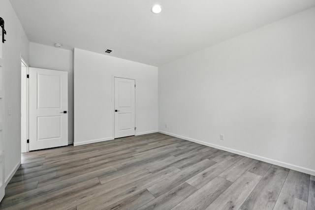 4 Willis Rd, Benton, ME 04901 - unfurnished bedroom featuring wood finished floors and recessed lighting