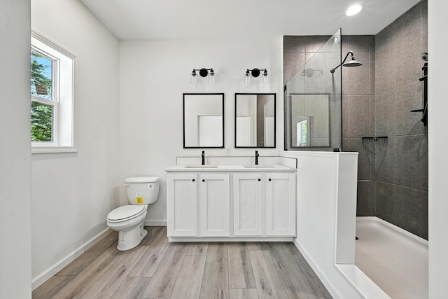 4 Willis Rd, Benton, ME 04901 - bathroom with double vanity, a tile shower, wood finished floors, and recessed lighting