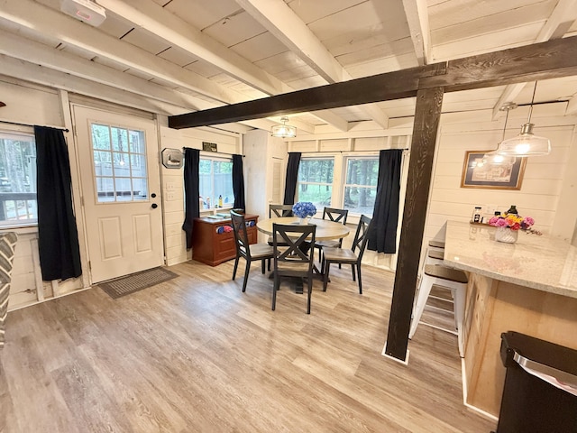 628 Springy Pond Rd, Otis, ME 04605 - dining space featuring light wood finished floors, healthy amount of natural light, beamed ceiling, and wood walls