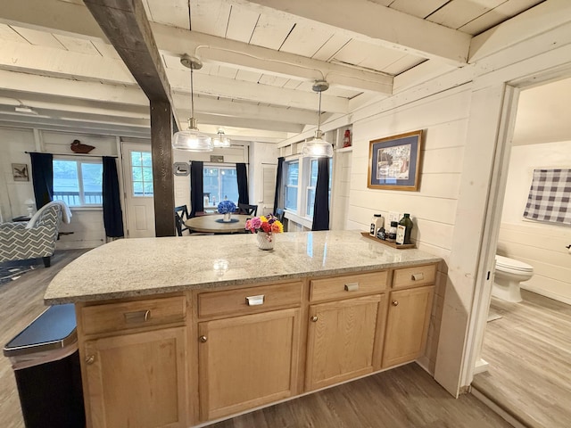 628 Springy Pond Rd, Otis, ME 04605 - kitchen with a peninsula, dark wood finished floors, light stone counters, open floor plan, and a wood ceiling with exposed beams