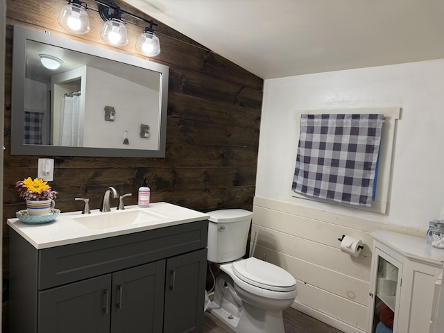 628 Springy Pond Rd, Otis, ME 04605 - bathroom with lofted ceiling, wood walls, vanity, and wood finished floors