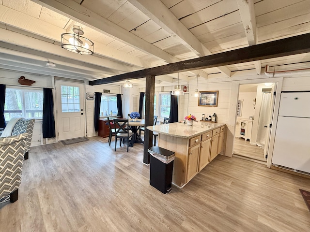 628 Springy Pond Rd, Otis, ME 04605 - kitchen with freestanding refrigerator, light wood finished floors, a peninsula, light brown cabinets, and healthy amount of natural light