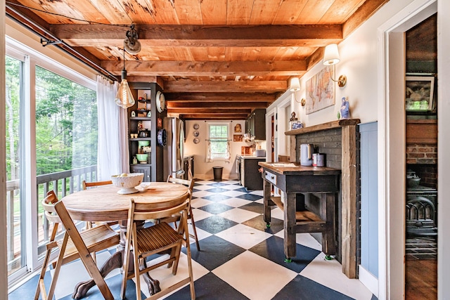 860 Gardiner Rd, Wiscasset, ME 04578 - dining space with a wooden ceiling with exposed beams, dark flooring, and a fireplace