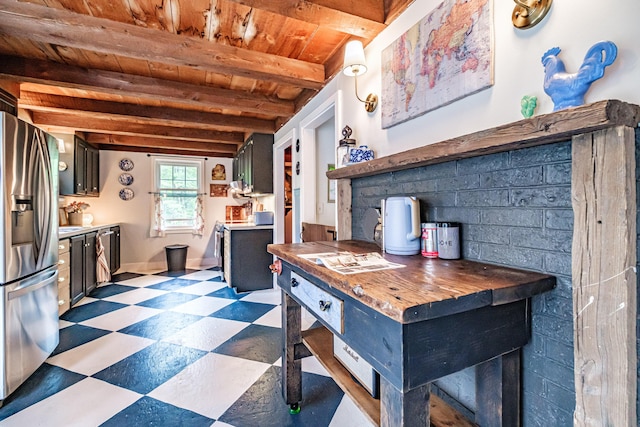 860 Gardiner Rd, Wiscasset, ME 04578 - kitchen with stainless steel refrigerator with ice dispenser, dark flooring, a wooden ceiling with exposed beams, and wood counters