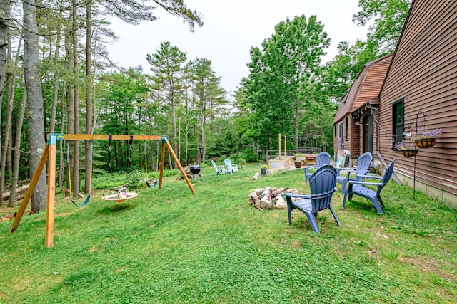 860 Gardiner Rd, Wiscasset, ME 04578 - view of grassy yard featuring a playground, an outdoor fire pit, and view of scattered trees