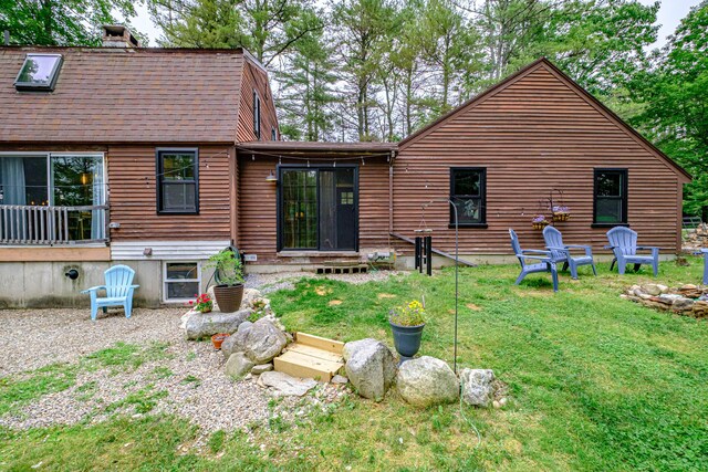 860 Gardiner Rd, Wiscasset, ME 04578 - rear view of house with a chimney, entry steps, a yard, and roof with shingles