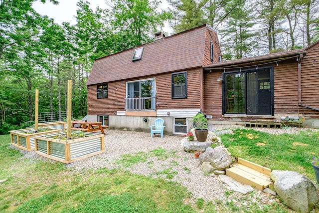 860 Gardiner Rd, Wiscasset, ME 04578 - back of house featuring a garden, a chimney, a shingled roof, a yard, and a gambrel roof