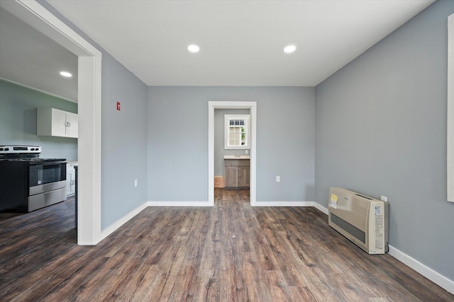 159 N St, Calais, ME 04619 - unfurnished room with heating unit, dark wood-style floors, and recessed lighting