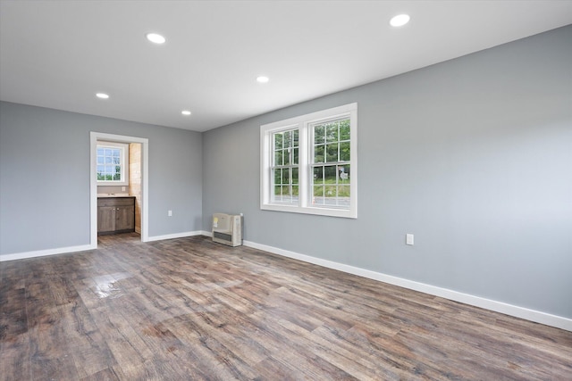 159 N St, Calais, ME 04619 - spare room featuring healthy amount of natural light, dark wood-type flooring, recessed lighting, and heating unit