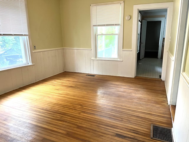 6 Autumn St, Lisbon, ME 04252 - unfurnished room featuring wood-type flooring and a wainscoted wall