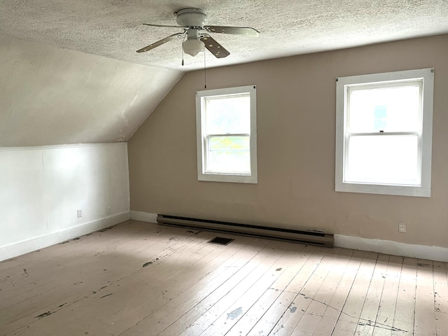 6 Autumn St, Lisbon, ME 04252 - bonus room featuring a ceiling fan, a textured ceiling, baseboard heating, wood-type flooring, and lofted ceiling