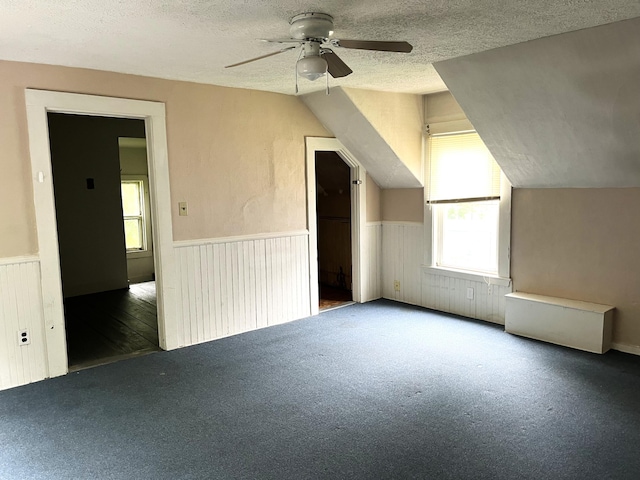 6 Autumn St, Lisbon, ME 04252 - bonus room featuring a wainscoted wall, a textured ceiling, a ceiling fan, carpet, and lofted ceiling