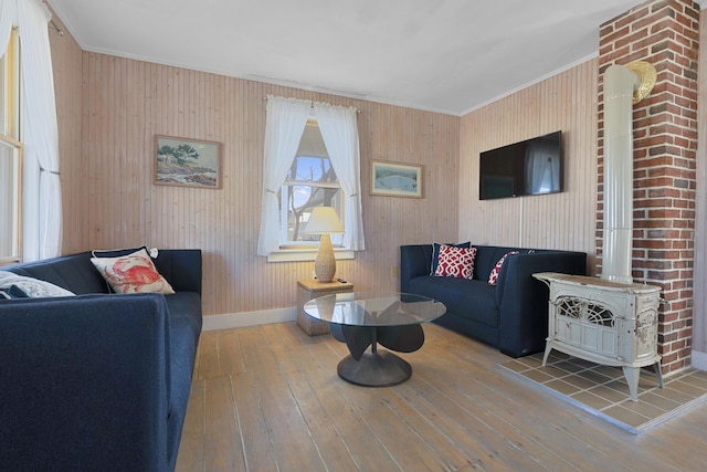 39 Main Ave, Saco, ME 04072 - living area with a wood stove, wood-type flooring, ornamental molding, and wood walls