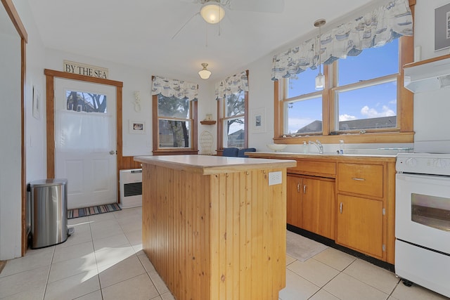 39 Main Ave, Saco, ME 04072 - kitchen featuring white electric range oven, a center island, light tile patterned floors, and light countertops