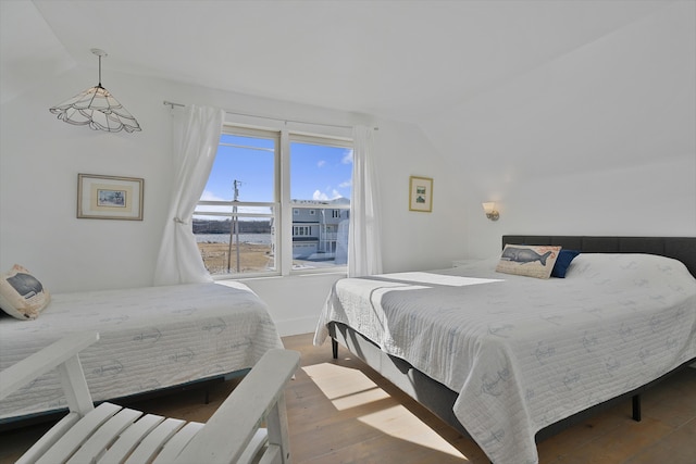 39 Main Ave, Saco, ME 04072 - bedroom with vaulted ceiling, wood finished floors, and a water view