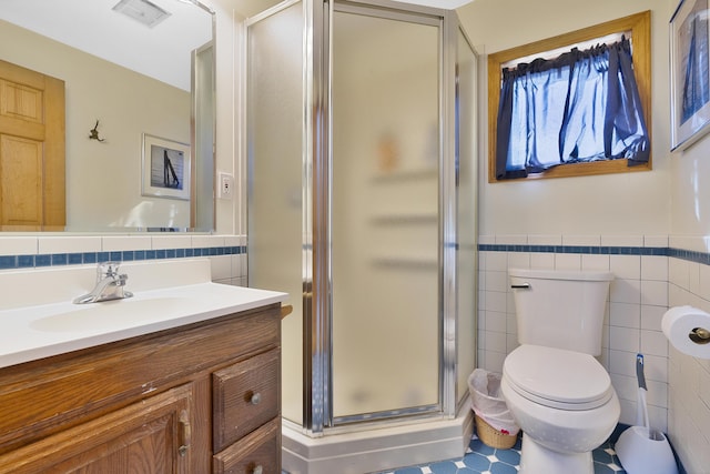 39 Main Ave, Saco, ME 04072 - bathroom featuring tile walls, vanity, a shower stall, and a wainscoted wall