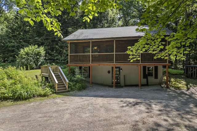 31 Convene Rd, Sebago, ME 04029 - chalet / cabin featuring stairs, a wooden deck, a sunroom, and a shingled roof