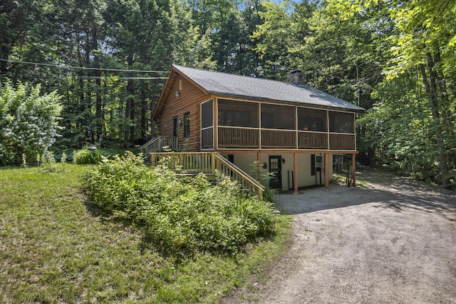 31 Convene Rd, Sebago, ME 04029 - view of front of home featuring a sunroom, stairway, a deck, roof with shingles, and a wooded view
