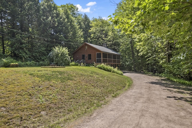 31 Convene Rd, Sebago, ME 04029 - view of front of property featuring a front yard, driveway, a view of trees, and a chimney