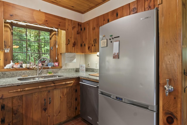 31 Convene Rd, Sebago, ME 04029 - kitchen featuring stainless steel appliances, light stone counters, and brown cabinets