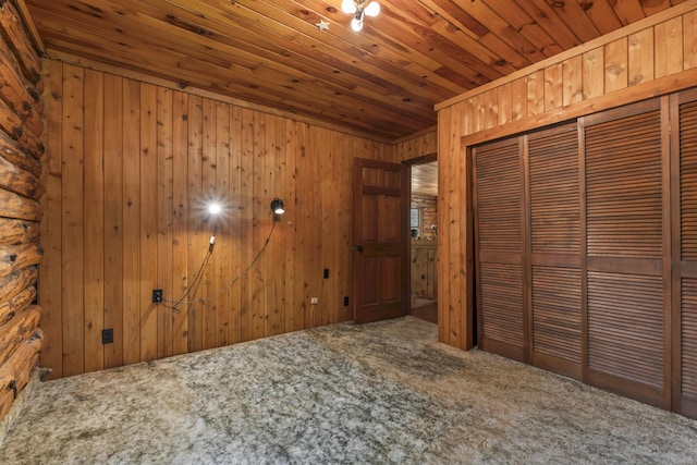 31 Convene Rd, Sebago, ME 04029 - unfurnished bedroom featuring carpet flooring, wooden ceiling, a closet, and wooden walls