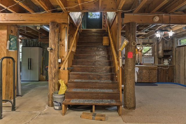 31 Convene Rd, Sebago, ME 04029 - stairway with unfinished concrete flooring, wood walls, and cooling unit