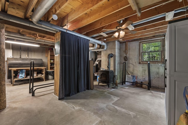31 Convene Rd, Sebago, ME 04029 - basement with a wood stove and oil tank