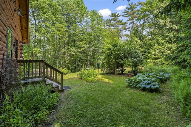 31 Convene Rd, Sebago, ME 04029 - view of green lawn featuring a wooden deck and a view of trees