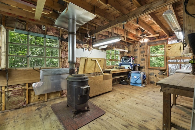 31 Convene Rd, Sebago, ME 04029 - miscellaneous room with a wood stove, hardwood / wood-style flooring, a wooden ceiling with exposed beams, plenty of natural light, and wood walls