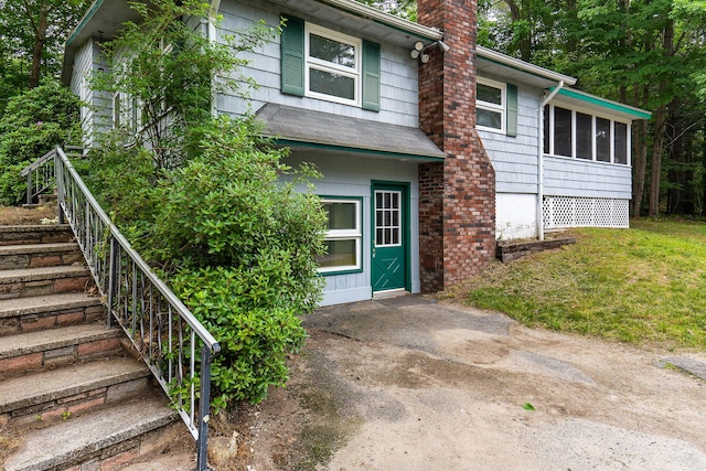 106 Bowdoinham Rd, Sabattus, ME 04280 - view of front of property with stairs, a chimney, and a sunroom