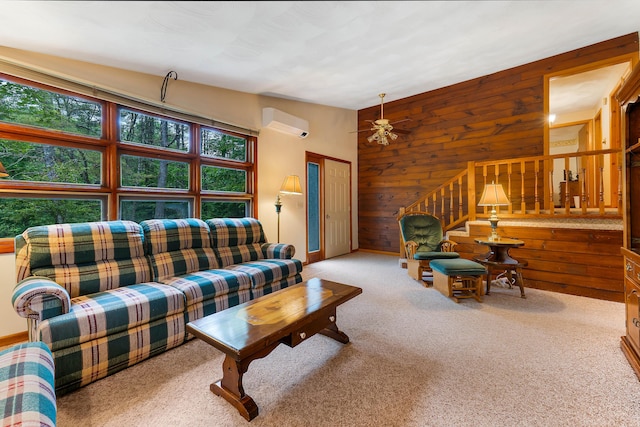 106 Bowdoinham Rd, Sabattus, ME 04280 - carpeted living area with wooden walls, an AC wall unit, a ceiling fan, and stairway