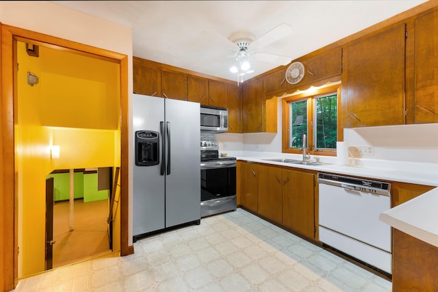 106 Bowdoinham Rd, Sabattus, ME 04280 - kitchen with stainless steel appliances, a ceiling fan, light countertops, brown cabinetry, and light flooring