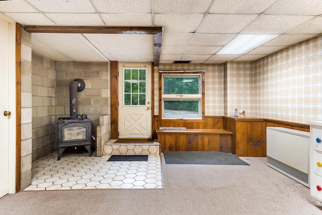 106 Bowdoinham Rd, Sabattus, ME 04280 - miscellaneous room with carpet floors, a wood stove, and a paneled ceiling