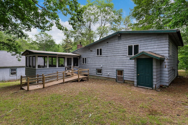 106 Bowdoinham Rd, Sabattus, ME 04280 - back of property featuring a sunroom, a chimney, and a wooden deck