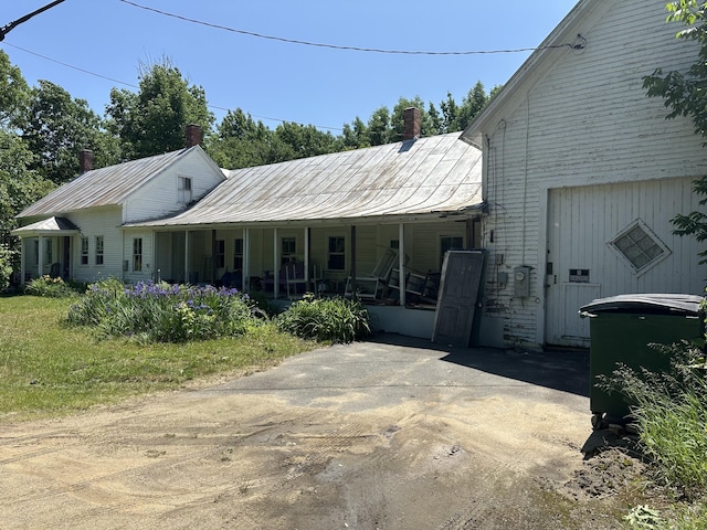 50 Church St, Weld, ME 04285 - view of front of house with a porch, a metal roof, and a chimney