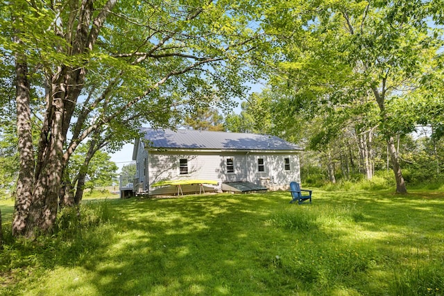 1165 Castine Rd, Penobscot, ME 04476 - rear view of house with a yard and a metal roof