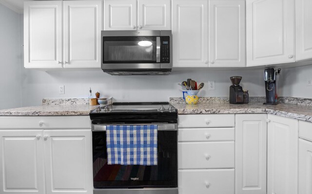 1165 Castine Rd, Penobscot, ME 04476 - kitchen featuring appliances with stainless steel finishes, white cabinets, and light stone countertops