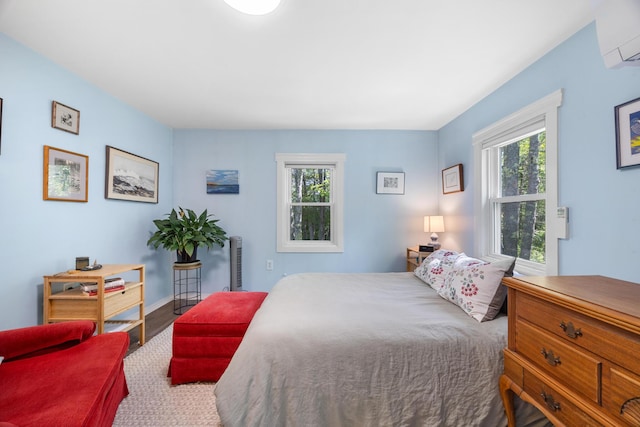 1165 Castine Rd, Penobscot, ME 04476 - bedroom featuring a wall mounted air conditioner and wood finished floors
