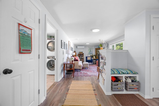 1165 Castine Rd, Penobscot, ME 04476 - hallway with stacked washer / dryer and wood finished floors