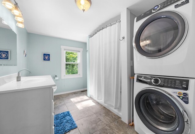 1165 Castine Rd, Penobscot, ME 04476 - laundry area with stacked washer and clothes dryer and baseboards