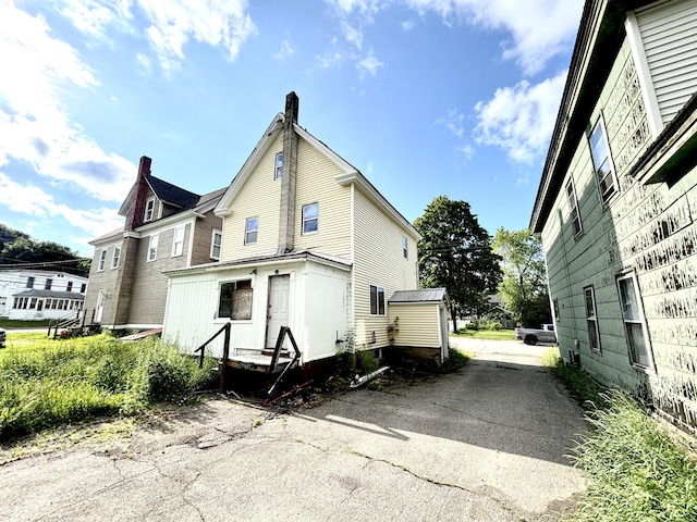 84 Pine St, Millinocket, ME 04462 - view of side of property featuring a chimney