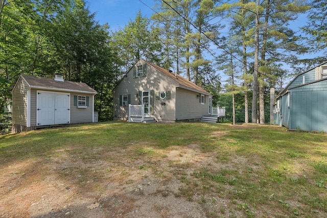 115 34th St, Acton, ME 04001 - back of property with a storage unit, a yard, and a chimney