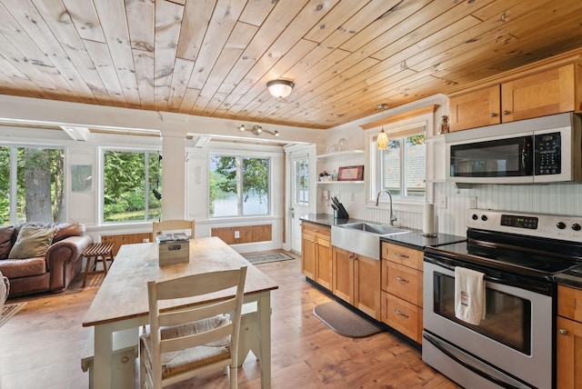 115 34th St, Acton, ME 04001 - kitchen featuring stainless steel range with electric stovetop, wood ceiling, open floor plan, dark countertops, and plenty of natural light