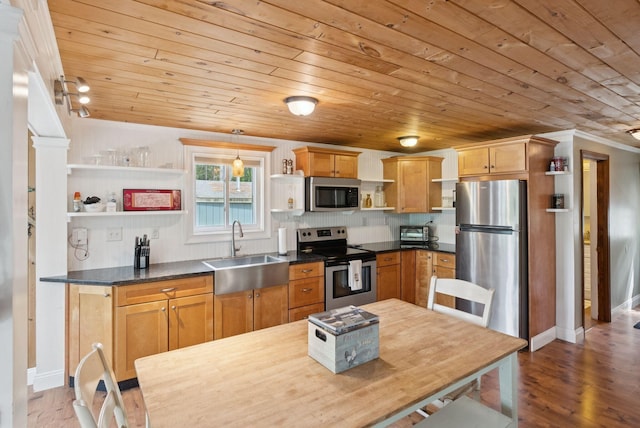 115 34th St, Acton, ME 04001 - kitchen with open shelves, stainless steel appliances, wood ceiling, dark countertops, and wood finished floors