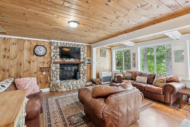 115 34th St, Acton, ME 04001 - living room with wood finished floors, a fireplace, wood walls, wood ceiling, and ornamental molding