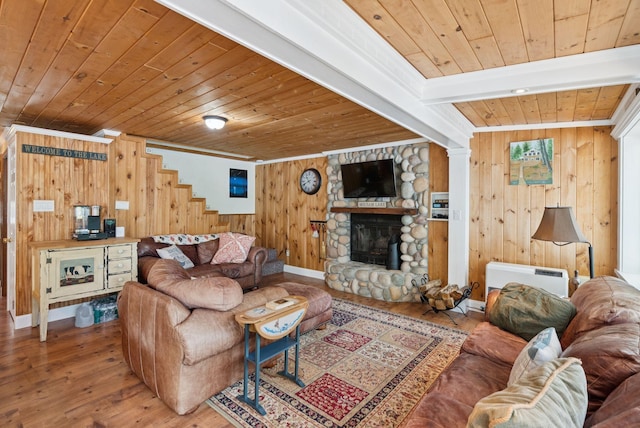 115 34th St, Acton, ME 04001 - living room featuring wooden ceiling, wooden walls, wood finished floors, stairs, and a fireplace