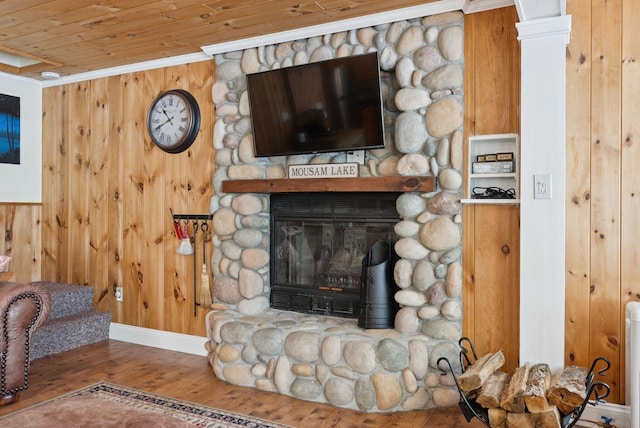 115 34th St, Acton, ME 04001 - detailed view of wooden walls, a fireplace, wood finished floors, ornamental molding, and wood ceiling